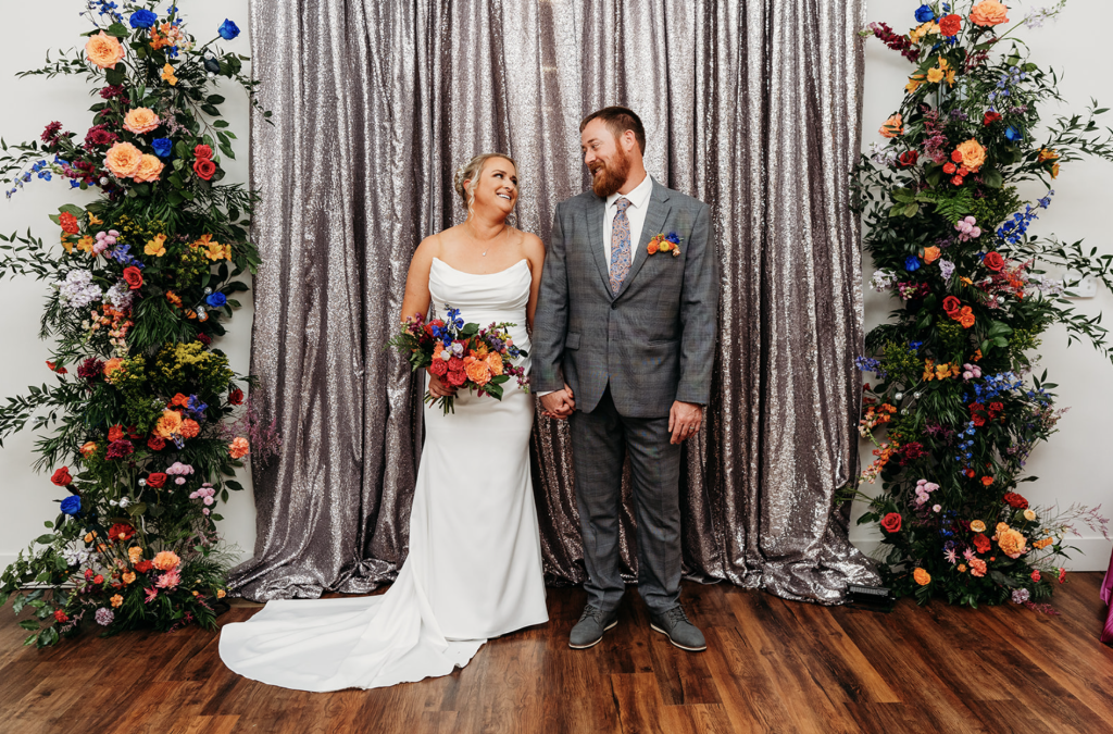 Silver Sequins curtains and colorful floral were the perfect backdrop for this wedding ceremony.