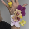Artistic corsage designed to give the illusion of floating floral.